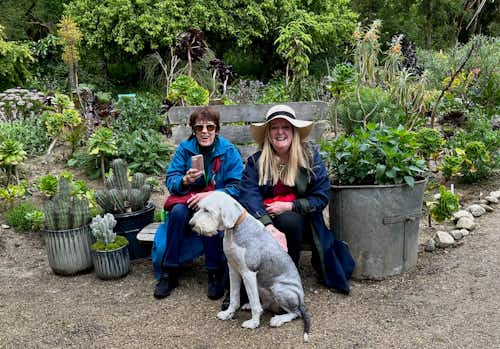 Jimi's canine companion sneaking a few pets from Rose and Kathy